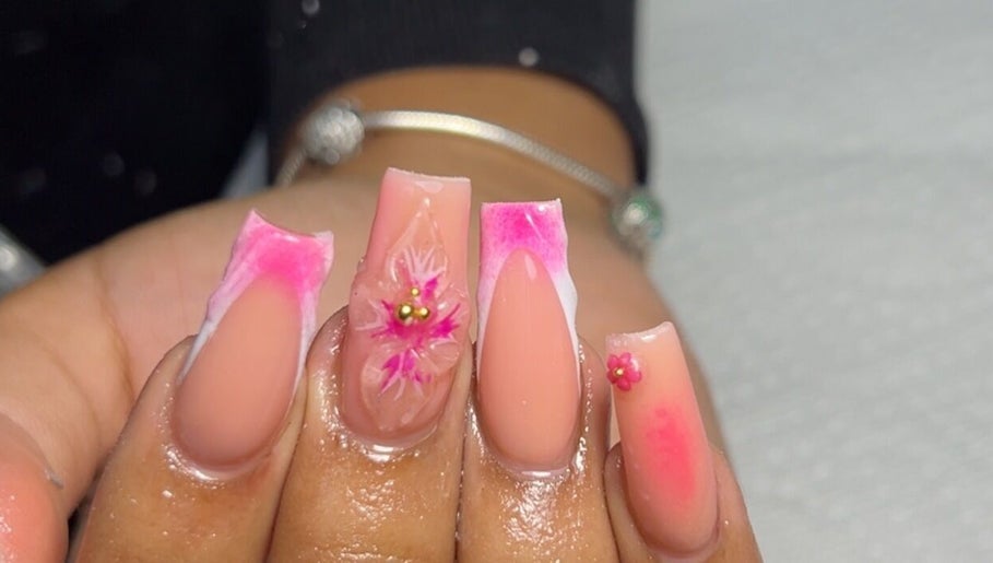 Intricate floral nail art at Sheia’s Nail Gallery, Nassau, New Providence, BS with pink accents.