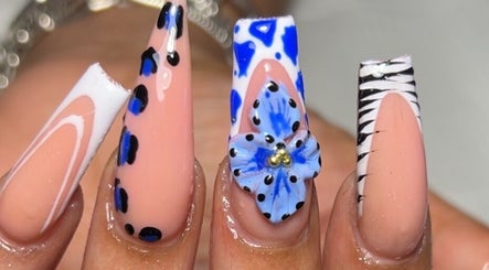 Artistic nail designs with blue flower detail at Sheia’s Nail Gallery, Nassau, New Providence, BS.