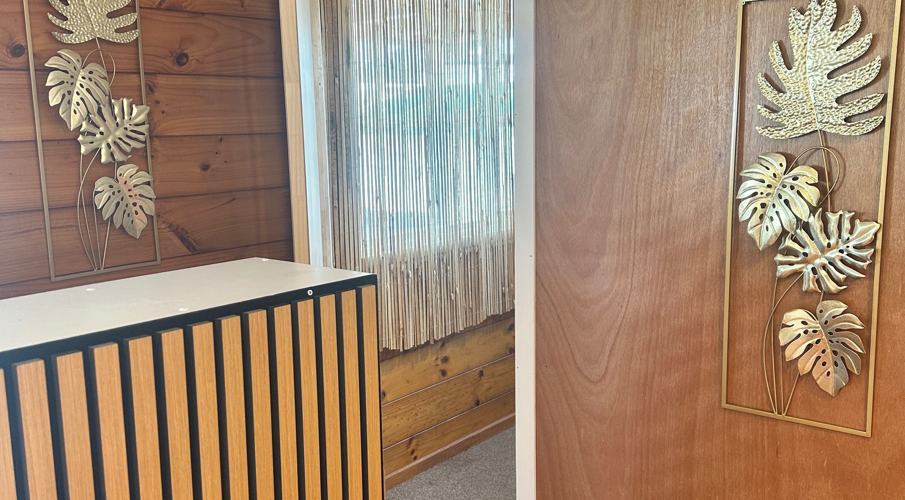 Elegant decor at Waipu Treatment Room, featuring wooden accents and gold leaf art, Waipu, Northland Region, NZ.