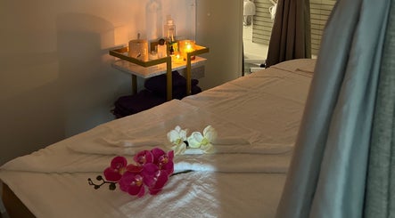 Cozy massage room with candles and flowers at Mol Thai Therapy, Doncaster, England, GB.