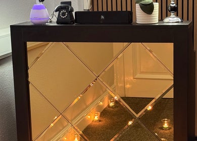Mol Thai Therapy's elegant mirrored table with ambient candles in Doncaster, England, GB.