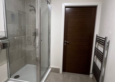 Modern shower area in Mol Thai Therapy, Doncaster, England, GB, with sleek design and calming neutral tones.