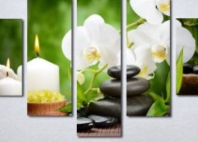 Relaxing spa setting at Adriatic Miracle Spa Massage, Folsom, California, US with candles and stones.