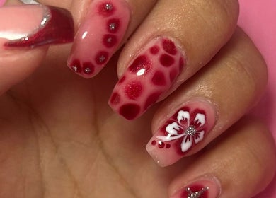 Elegant floral nail design at Beauty Lounge by Isabelle, Penygroes, Wales, GB showcasing red and white tones.