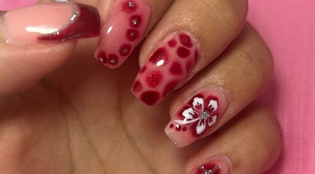 Elegant floral nail design at Beauty Lounge by Isabelle, Penygroes, Wales, GB showcasing red and white tones.