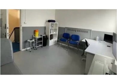 Modern therapy room at MH Sports Massage, London, England, GB, featuring cozy seating and treatment space.