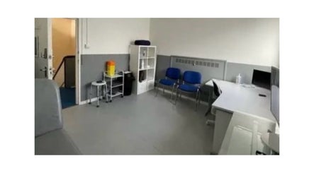 Modern therapy room at MH Sports Massage, London, England, GB, featuring cozy seating and treatment space.