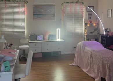 Elegant beauty room at Dollhaven_co in Walmsley, Western Australia, AU featuring a treatment bed and chic decor.
