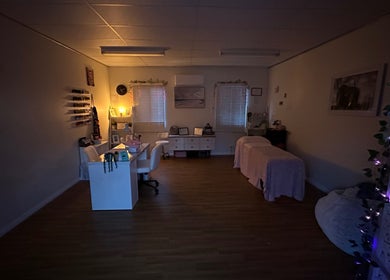 Relaxing treatment room at Dollhaven_co, Walmsley, Western Australia, AU, featuring ambient lighting and comfortable beds.