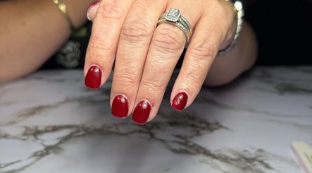 Elegant red manicure at Dollhaven Co, Walmsley, Western Australia, AU, showcasing polished nails.