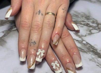 Elegant nail design with bows and gold at Dollhaven Co, Walmsley, Western Australia, AU.