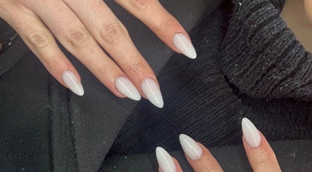 Sophisticated white manicured nails at La - Fabulous in Boksburg, Gauteng, ZA, on a black fabric background.