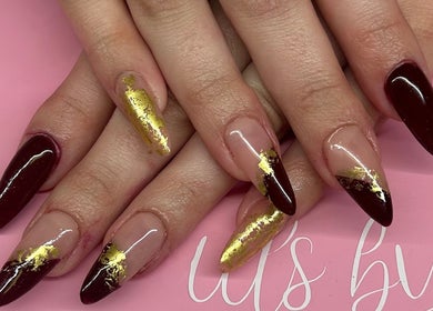 Stylish burgundy nails with gold accents at La - Fabulous, Boksburg, Gauteng, ZA.