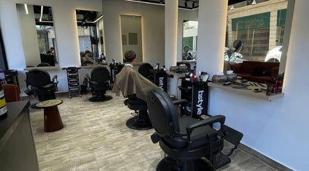 Interior view of Mohamed Gaber Salon in Alexandria Governorate, featuring modern salon chairs and styling stations.