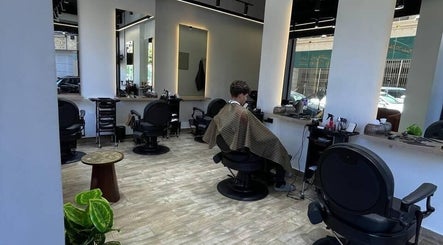 Modern interior of Mohamed Gaber Salon in Alexandria Governorate, EG, showcasing stylish barber chairs and mirrors.