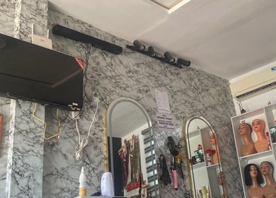 Revamp unisex salon interior in Ibadan, Oyo, NG with mirrors and stylish decor.