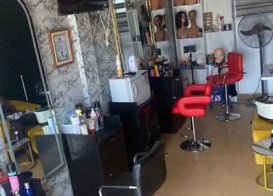 Revamp unisex salon in Ibadan, Oyo, NG features chic interior with styling stations and beauty products.