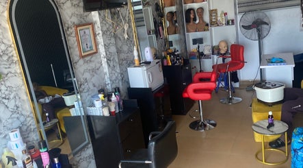 Revamp unisex salon in Ibadan, Oyo, NG features chic interior with styling stations and beauty products.