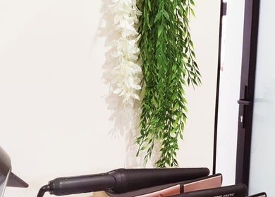 Stylish beauty tools at Ravaina Rain Studio, Cape Town, Western Cape, ZA, next to elegant floral decor.
