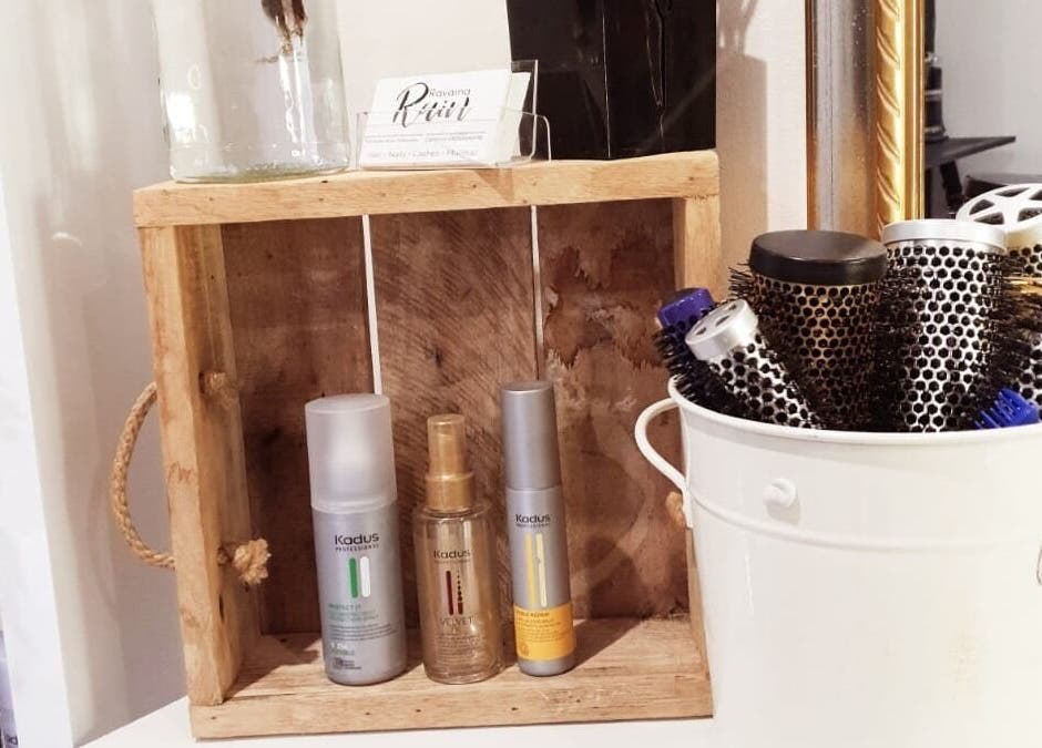 Hair products and brushes at Ravaina Rain Studio, Cape Town, Western Cape, ZA displayed in a wooden and ceramic holder.