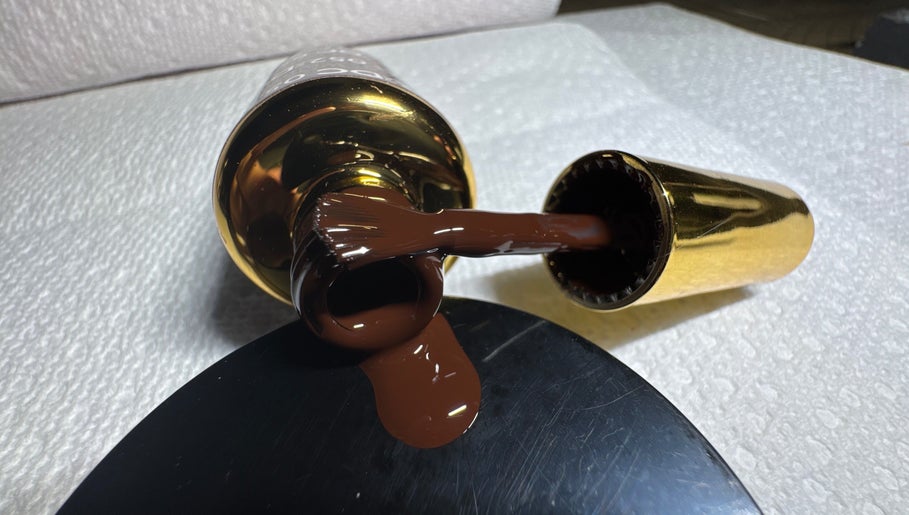 Nail polish spills from a golden bottle at Beautyybyycrystall, El Paso, Texas, US.