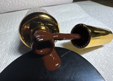 Nail polish spills from a golden bottle at Beautyybyycrystall, El Paso, Texas, US.
