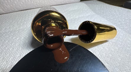 Nail polish spills from a golden bottle at Beautyybyycrystall, El Paso, Texas, US.