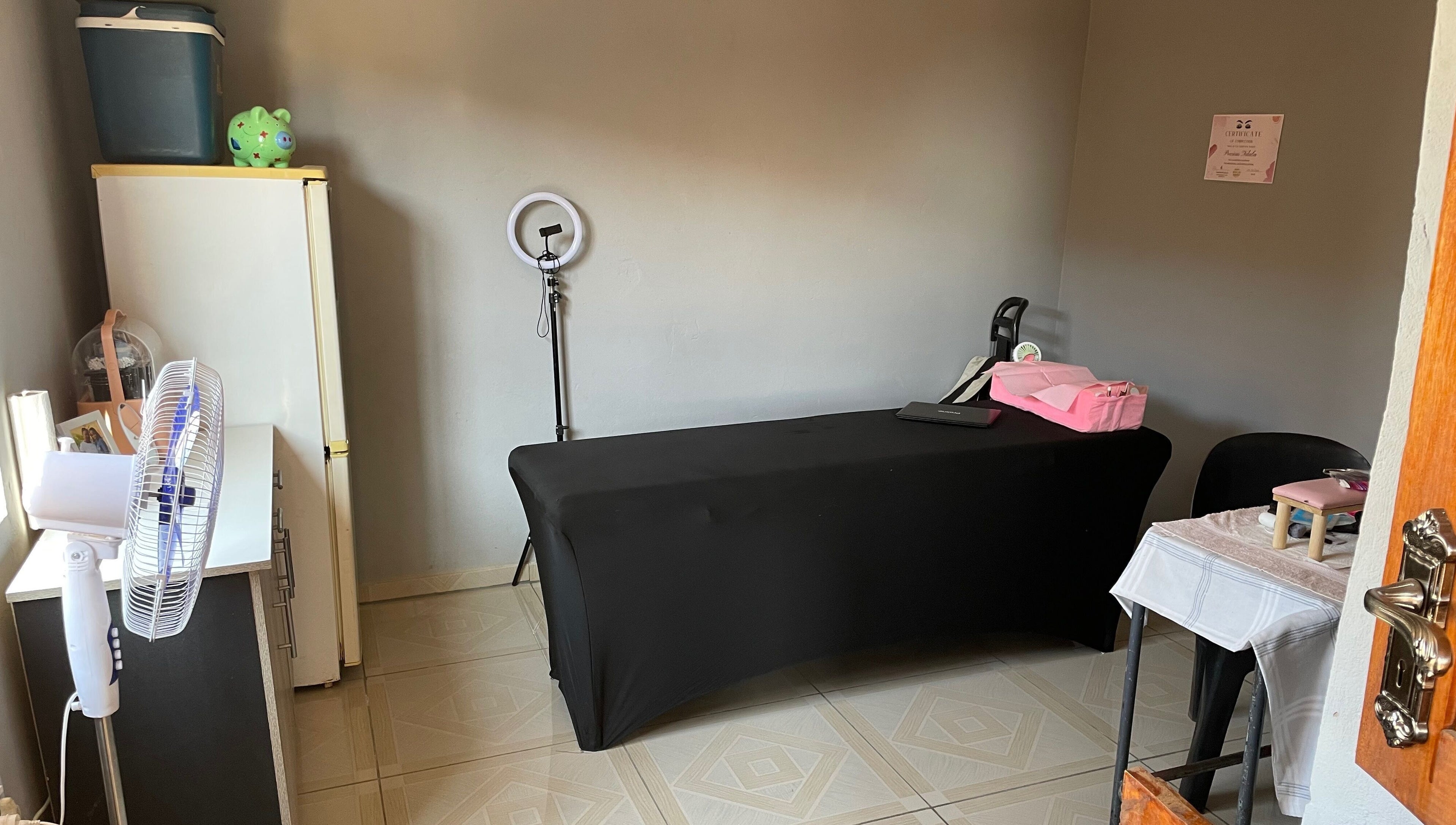 Cozy treatment room at KgoCgadi’s Beauty and Aesthetics in Carletonville, Gauteng, ZA with table and ring light.