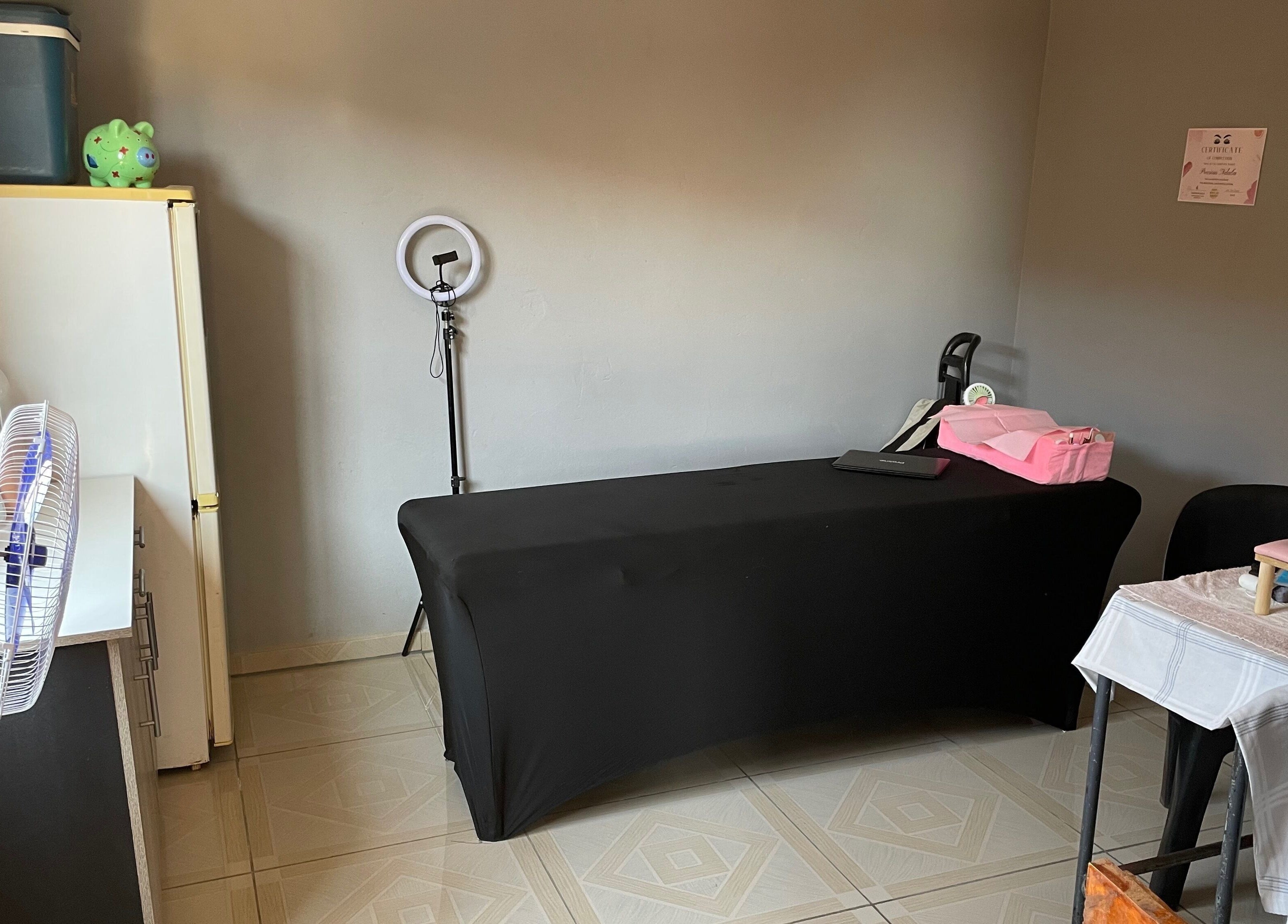 Cozy treatment room at KgoCgadi’s Beauty and Aesthetics in Carletonville, Gauteng, ZA with table and ring light.