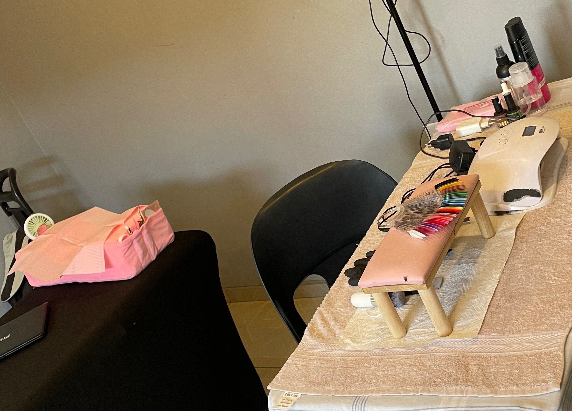 Nail station at KgoCgadi’s Beauty and Aesthetics, Carletonville, Gauteng, ZA, showcasing manicure tools and polish.