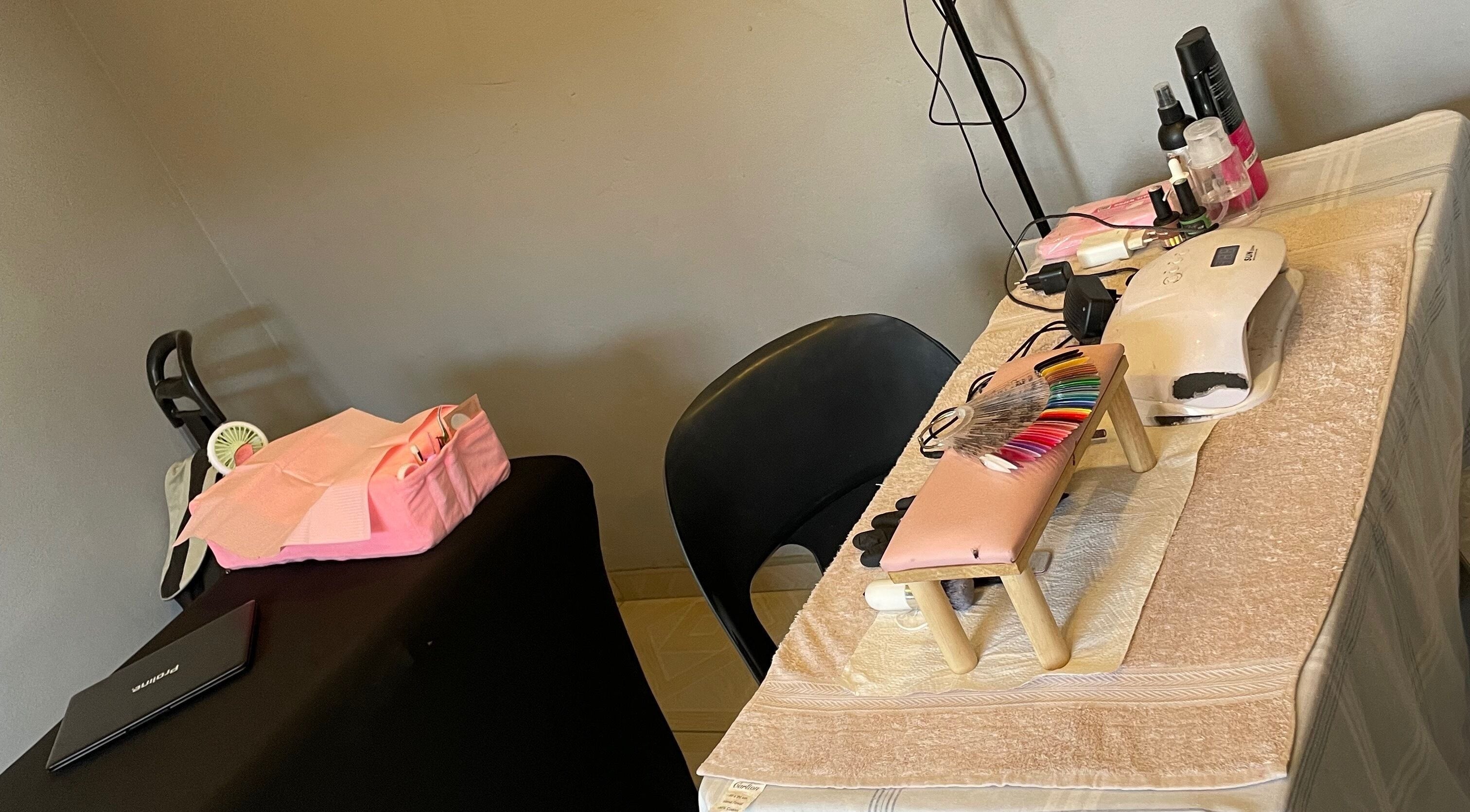 Nail station at KgoCgadi’s Beauty and Aesthetics, Carletonville, Gauteng, ZA, showcasing manicure tools and polish.