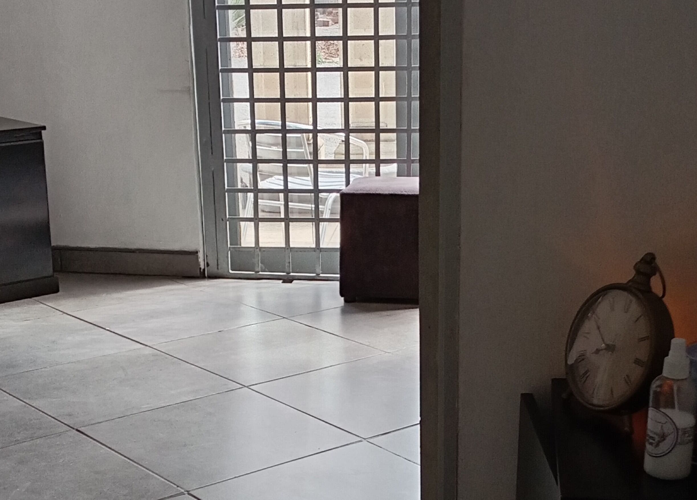 Cozy corner at Classic Nails and Beauty Salon by Chichi, Randburg, Gauteng, ZA with clock and decor.