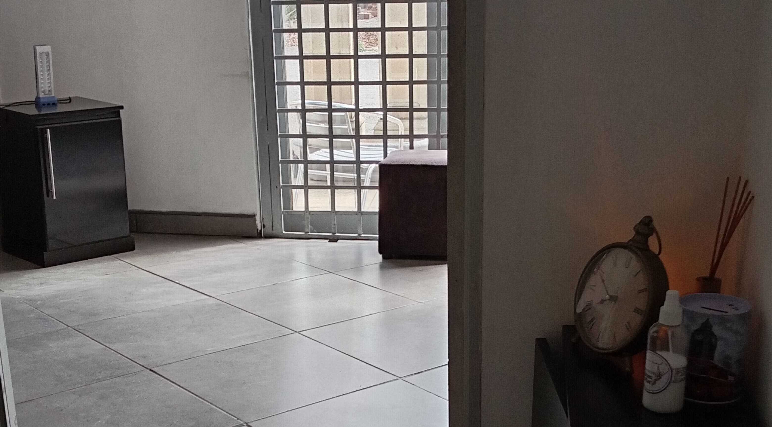 Cozy corner at Classic Nails and Beauty Salon by Chichi, Randburg, Gauteng, ZA with clock and decor.