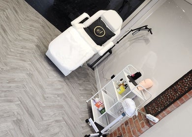 Modern treatment room at Emma Johnstone Medical Aesthetics in Wigan, England, GB featuring a sleek chair and equipment.