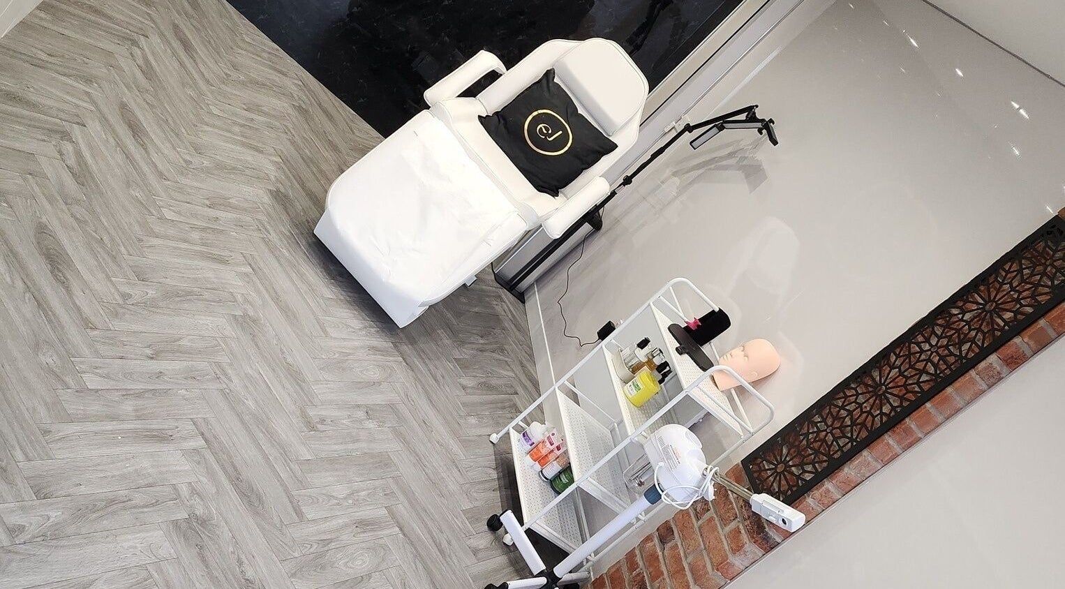 Modern treatment room at Emma Johnstone Medical Aesthetics in Wigan, England, GB featuring a sleek chair and equipment.