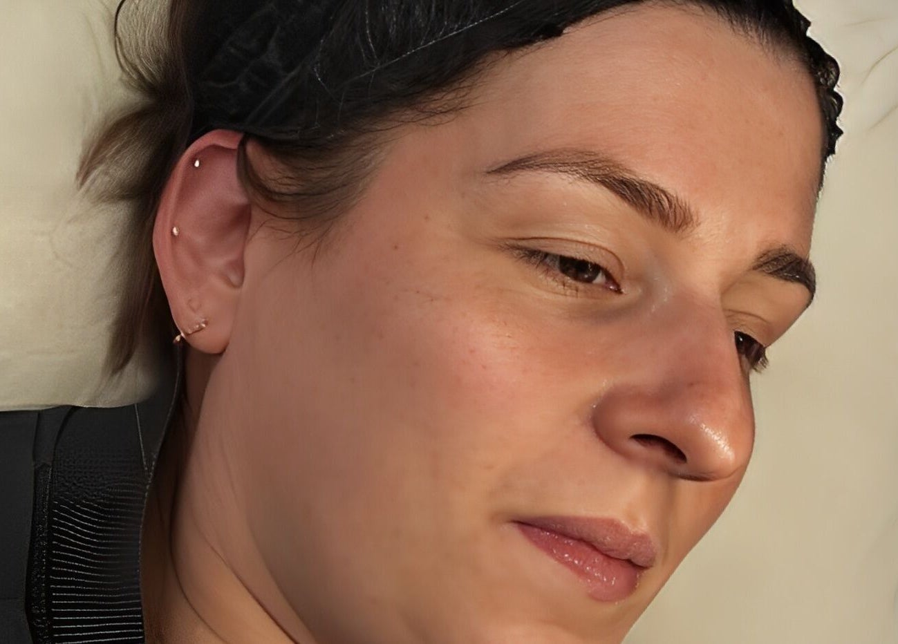 Close-up of a relaxed client at Skinology Studio, Evesham, England, GB, showcasing smooth skin post-treatment.