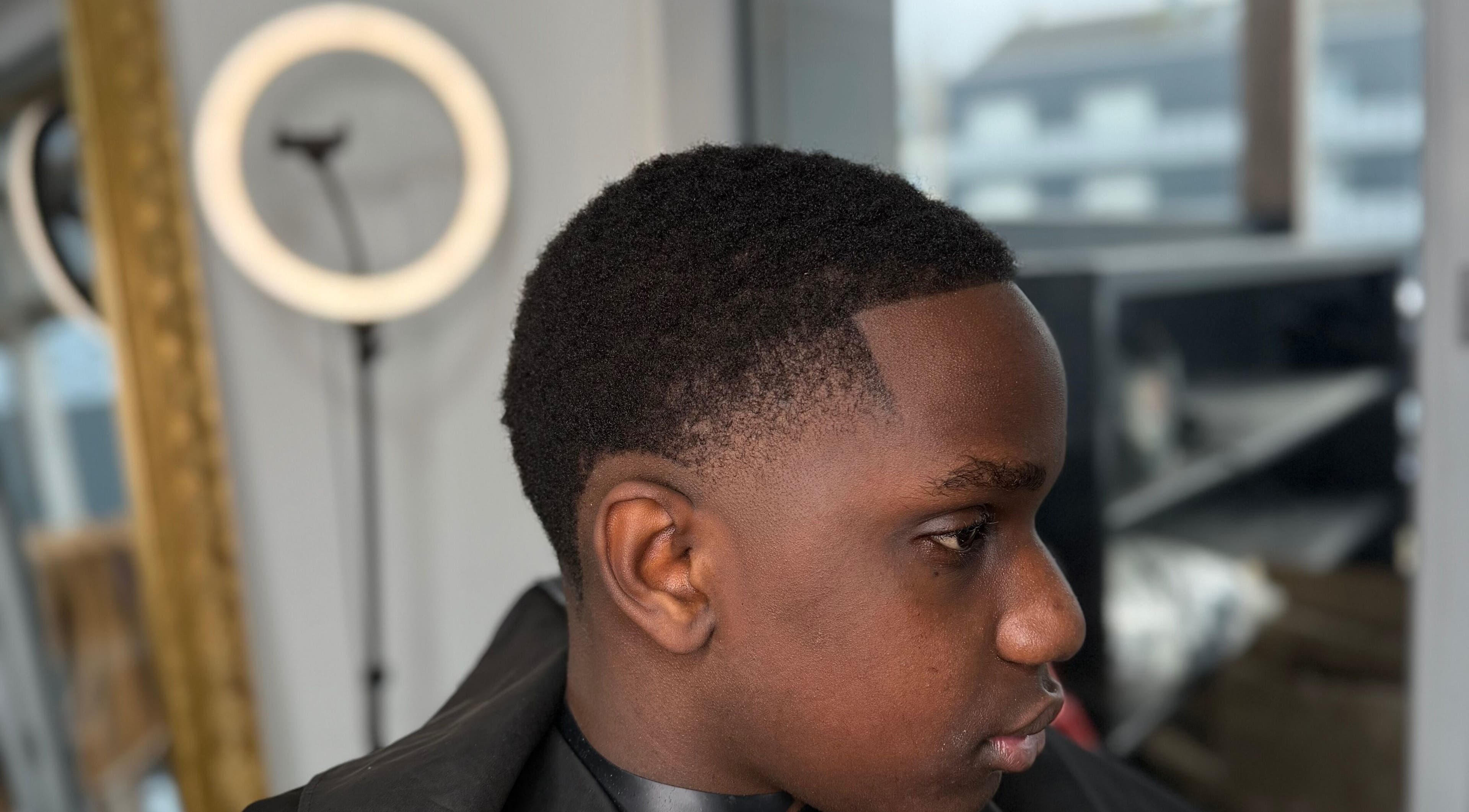 Coiffure moderne chez YP Studio Barber, Châteaubriant, Pays De La Loire, FR, avec un jeune homme stylé.