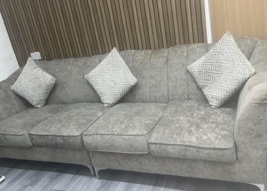 Elegant grey sofa with patterned pillows at Melissa Harper Hairdressing, Liverpool, England, GB.