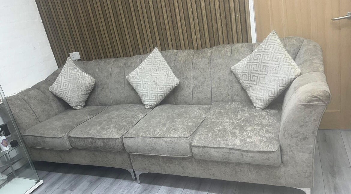 Elegant grey sofa with patterned pillows at Melissa Harper Hairdressing, Liverpool, England, GB.