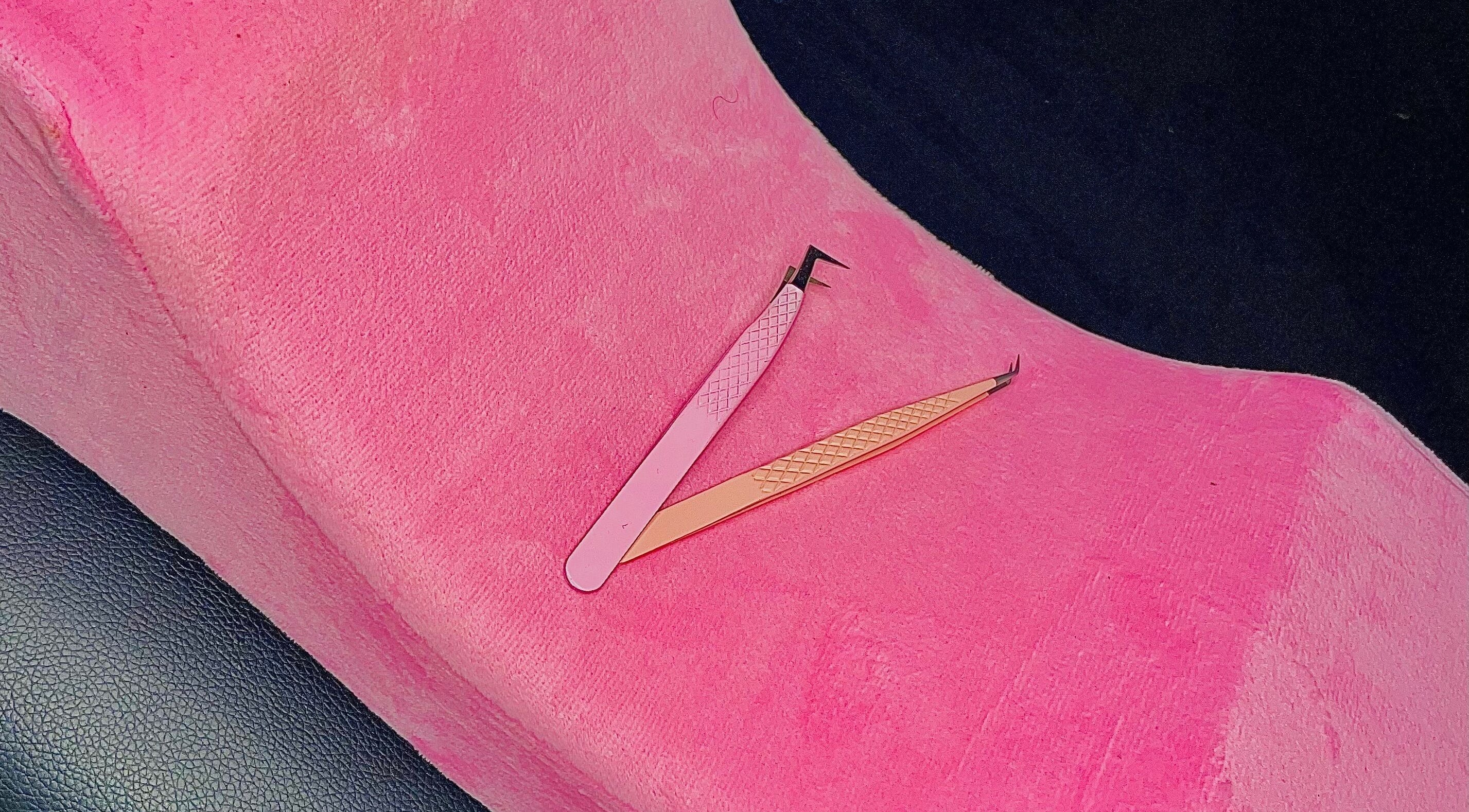Eyelash tweezers on pink cushion at Dee's Beauty Studio21, Pretoria, Gauteng, ZA.