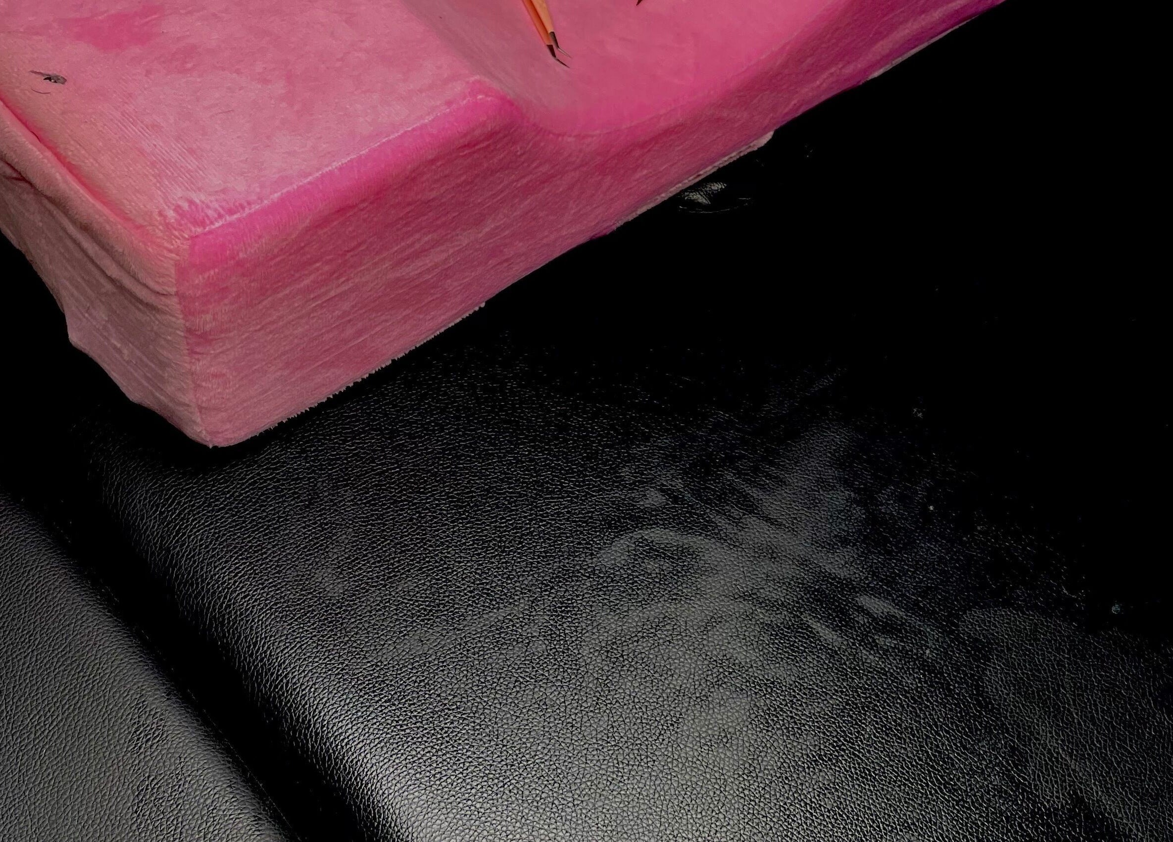 Pink plush cushion on a black chair at Dee's Beauty Studio21, Pretoria, Gauteng, ZA.