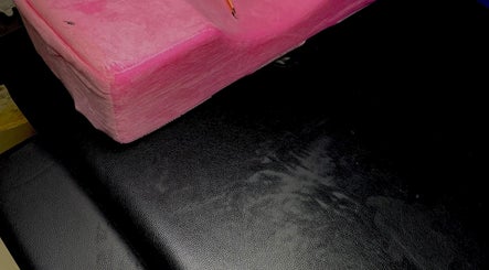 Pink plush cushion on a black chair at Dee's Beauty Studio21, Pretoria, Gauteng, ZA.