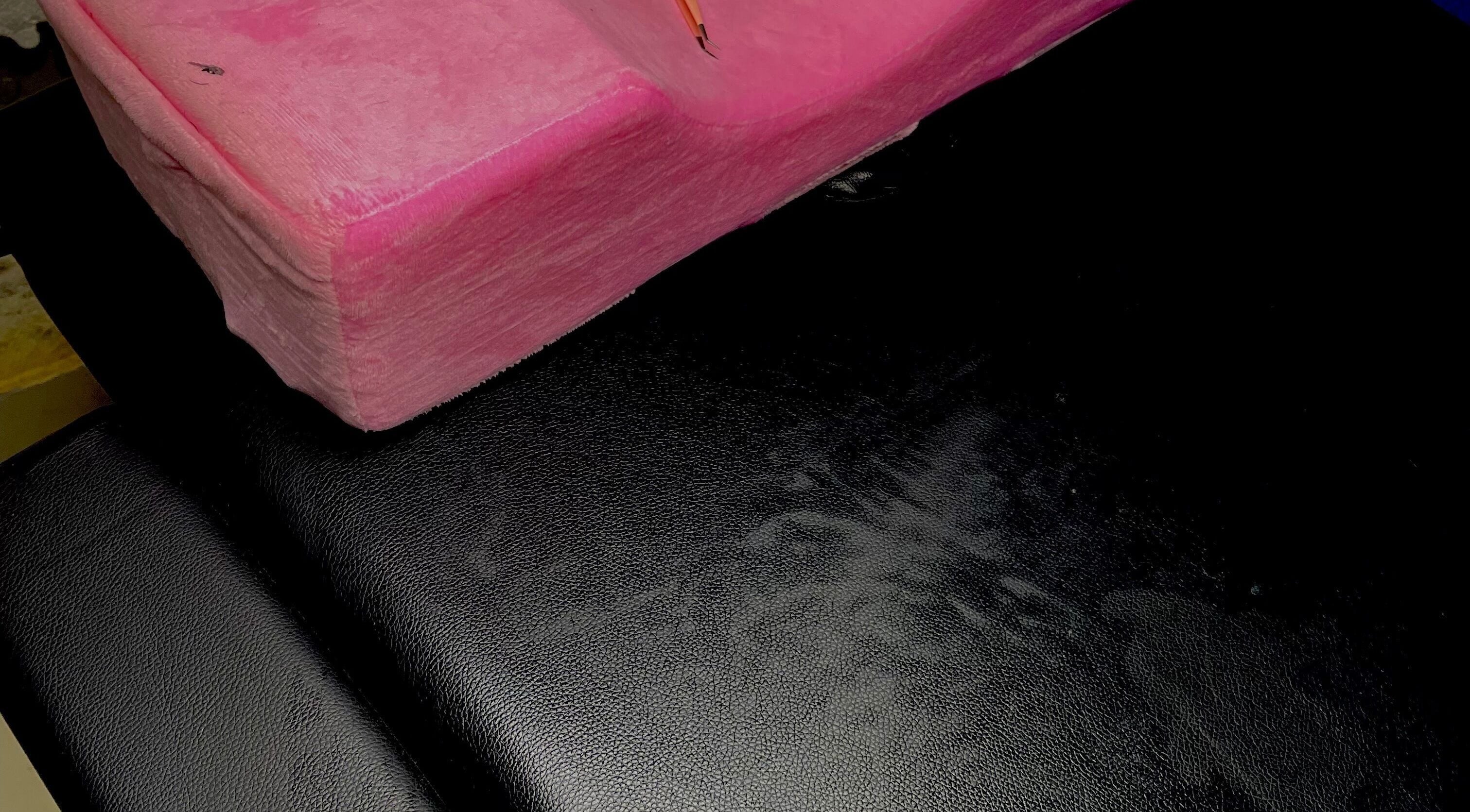 Pink plush cushion on a black chair at Dee's Beauty Studio21, Pretoria, Gauteng, ZA.