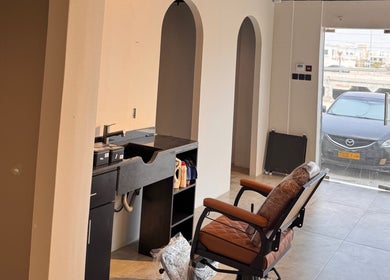 Modern salon setup at Mr Boombastic, Sib, Muscat Governorate, OM with stylish chair and workspace.