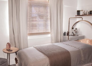 Relaxing treatment room at The Skin Sculptress, Richmond, England, GB, featuring a cozy massage bed and tranquil decor.
