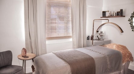 Relaxing treatment room at The Skin Sculptress, Richmond, England, GB, featuring a cozy massage bed and tranquil decor.