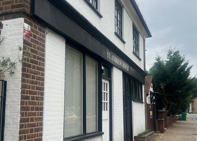 Exterior of The Skin Sculptress in Richmond, England, GB. A quaint brick building on a peaceful street.