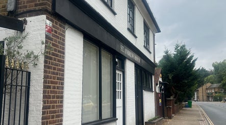 Exterior of The Skin Sculptress in Richmond, England, GB. A quaint brick building on a peaceful street.