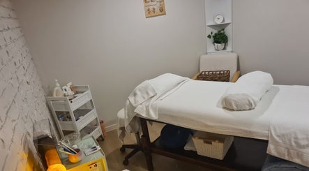 Cozy treatment room at Rare Earth Beauty in Kingscliff, New South Wales, AU with a massage table and spa essentials.