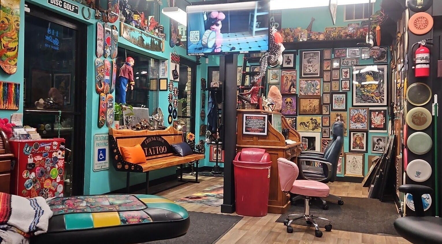 Inside Tony’s Tried & True Tattoo in Port Orchard, Washington, US, showcasing vibrant artwork and seating.